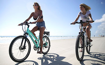 Two women riding bikes