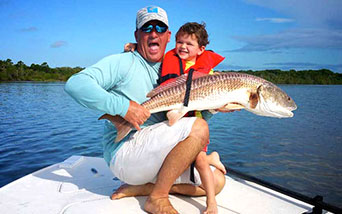 Father and son with large Red Drum Fish