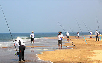 people fishing from the beach