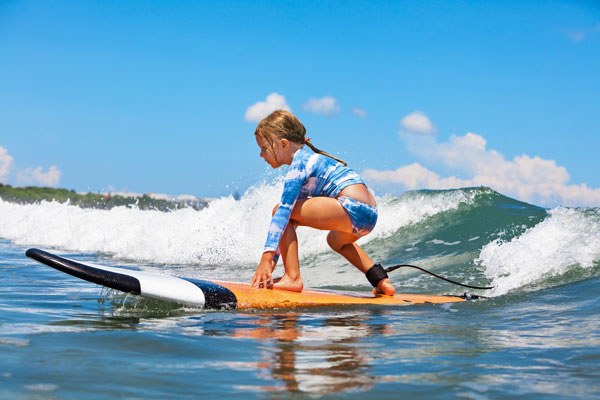 Young child getting a surf lesson on Cocoa Beach